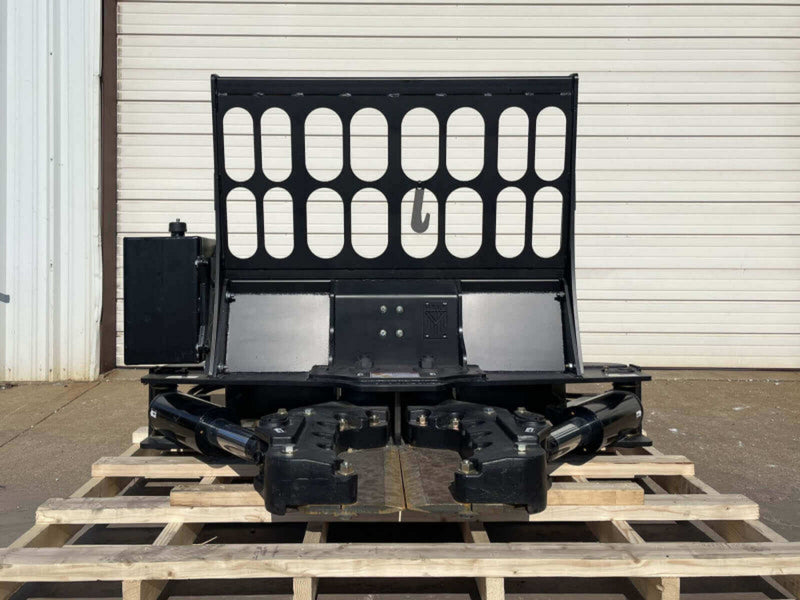Black metal grille on a wooden pallet in front of a white building