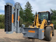 Wheel loader equipped with Forax loader-mounted implement boom attachment, showing extended boom with mulching head for vegetation management