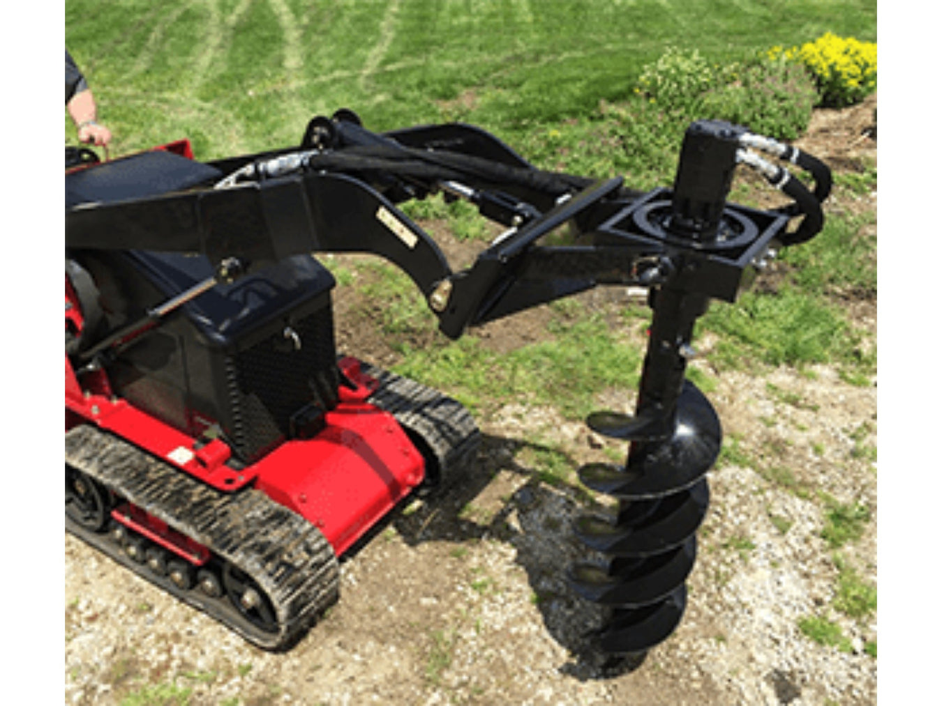 Mini skid-steer auger connected to loader, designed for post hole and tree planting tasks