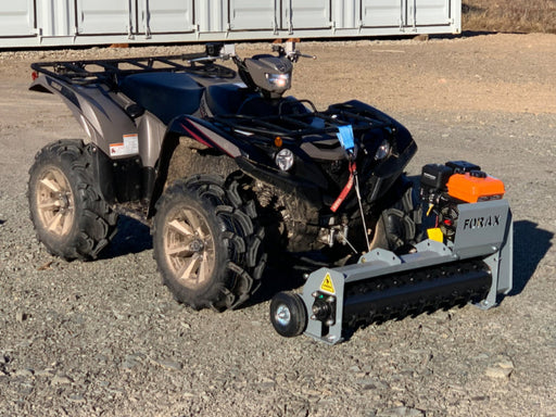 Forax GP36 ATV mulcher attachment mounted on an ATV, showing cutting drum and hitch connection.