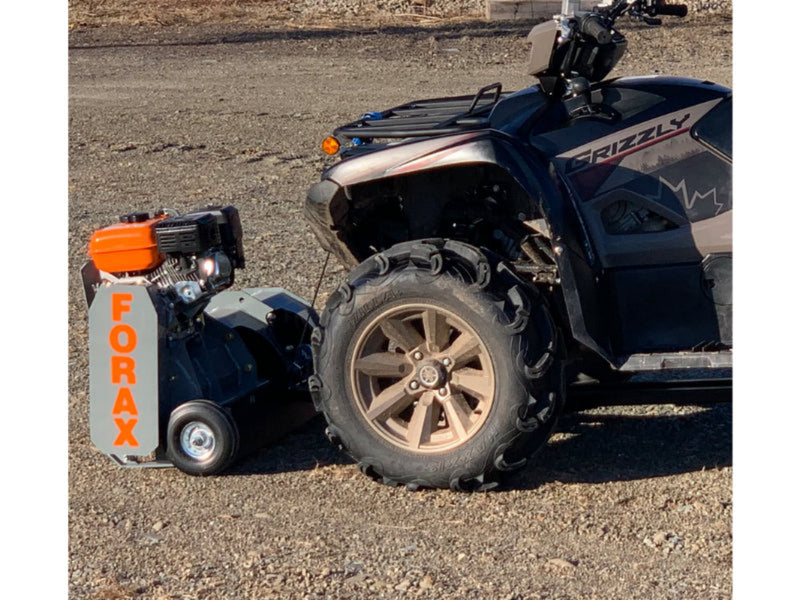ATV with a small engine attached on a gravel surface